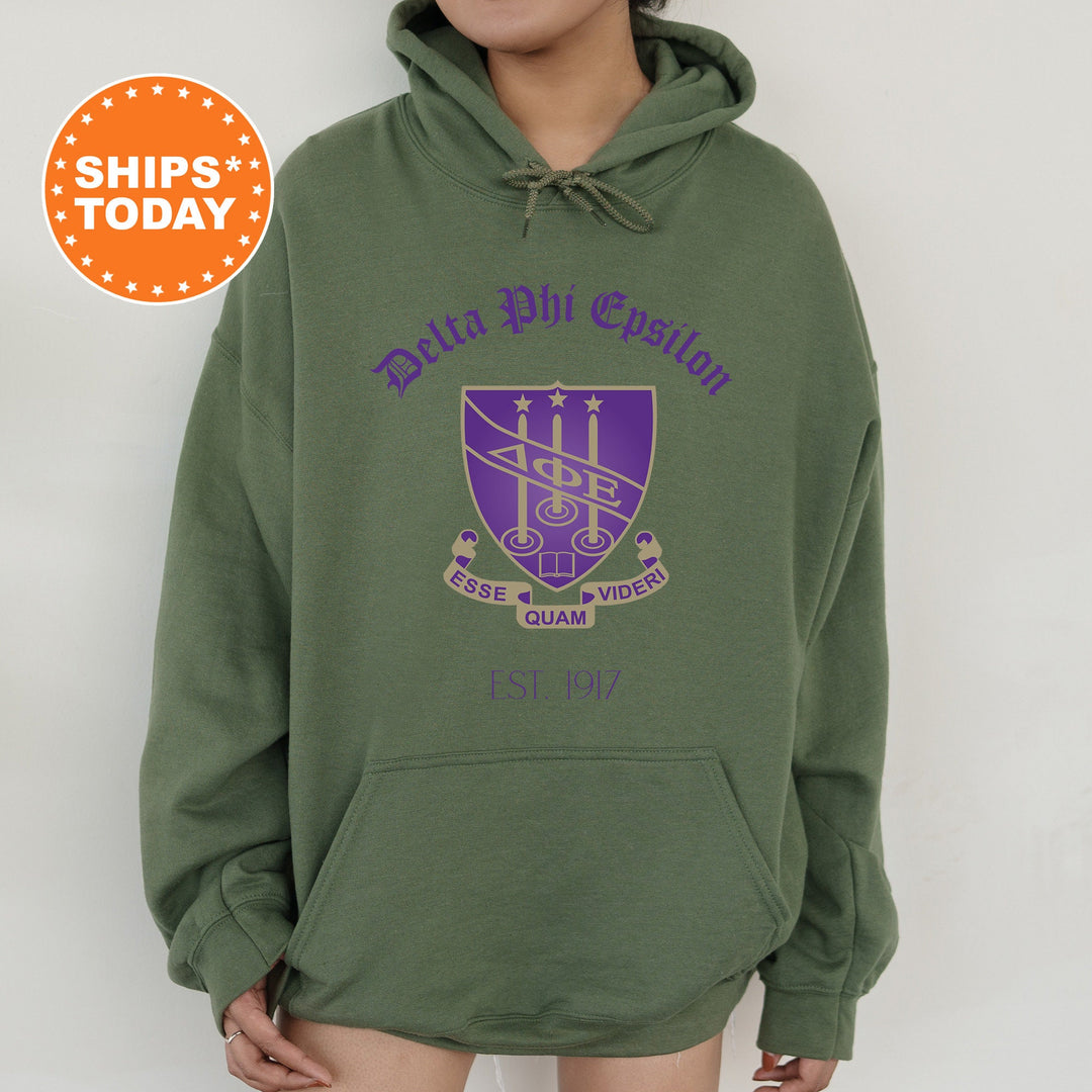 a woman wearing a green hoodie with purple lettering