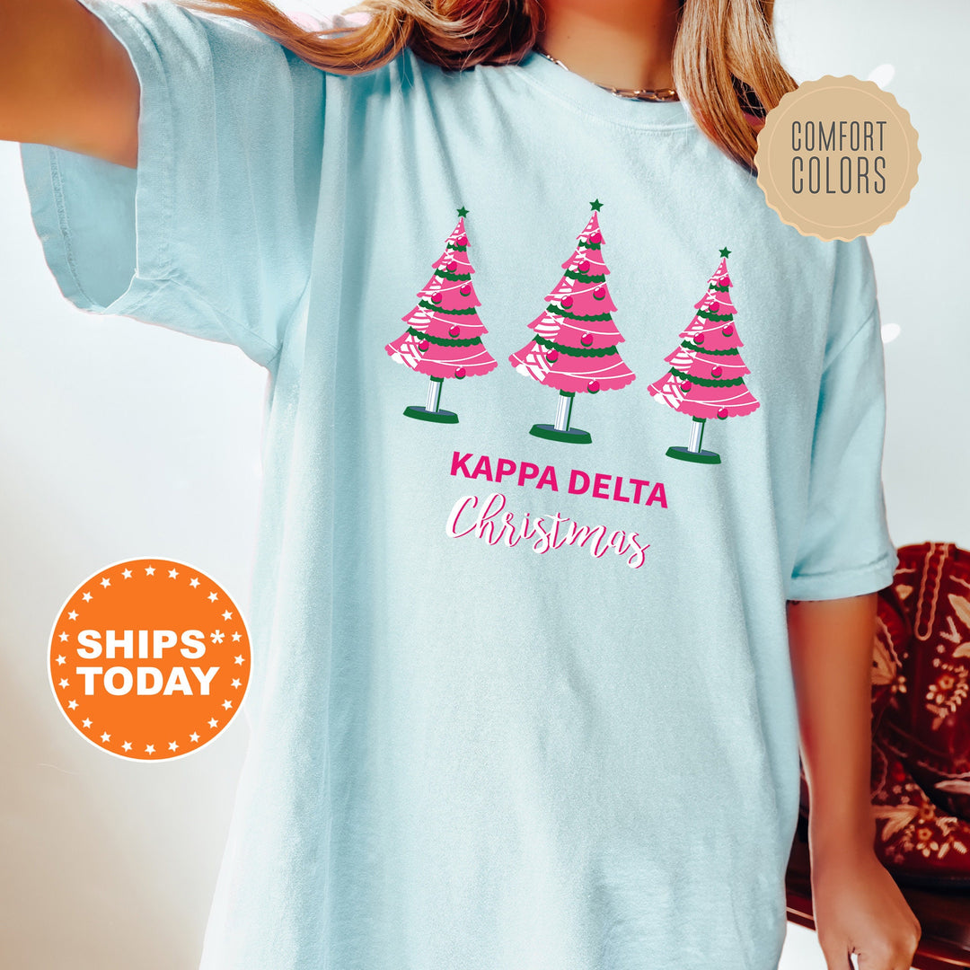 a woman wearing a t - shirt that says kapp delta christmas trees