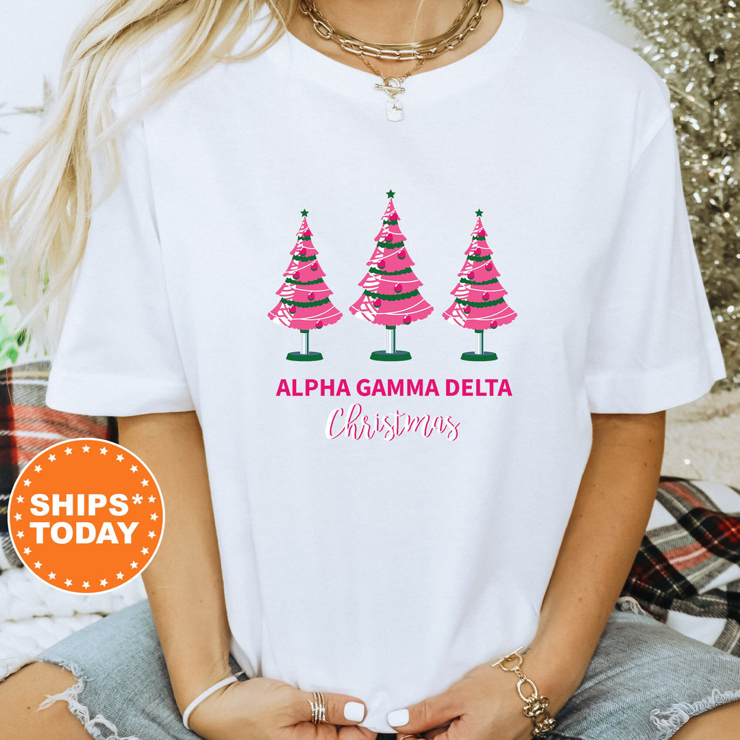 a woman wearing a white shirt with pink christmas trees on it