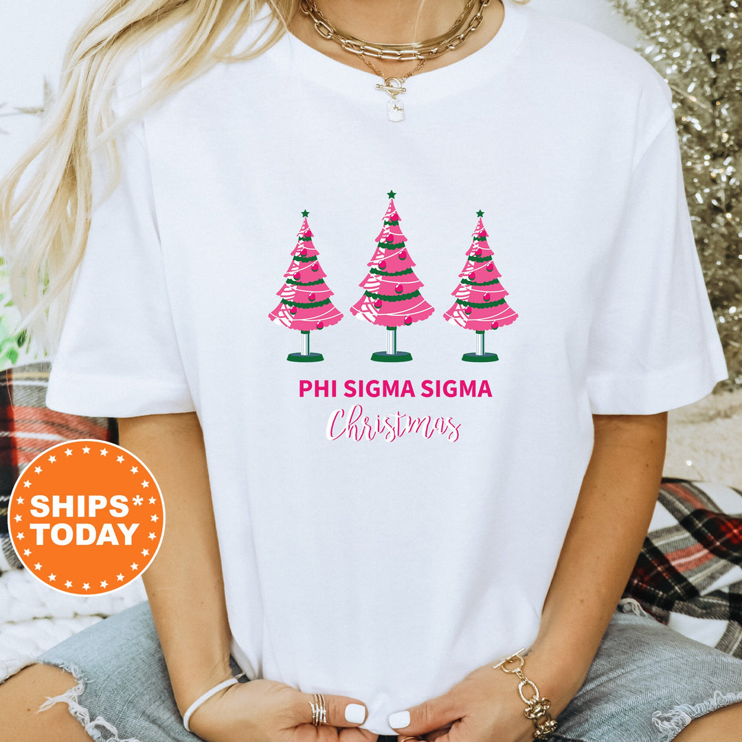 a woman wearing a white shirt with pink christmas trees on it