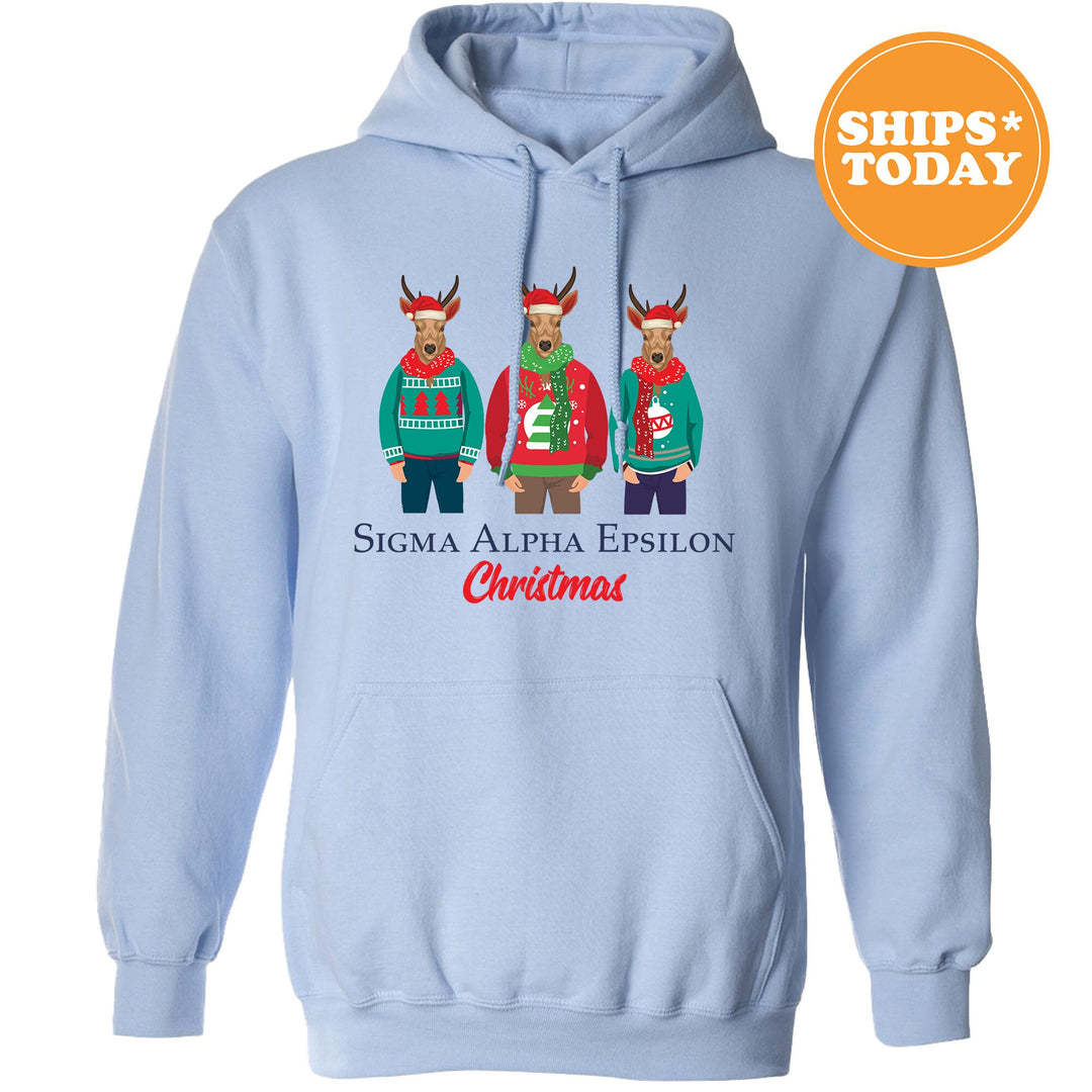 a blue hoodie with three reindeers wearing ugly sweaters