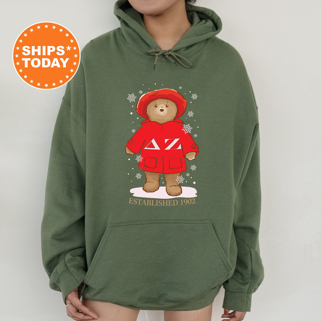 a person wearing a green hoodie with a bear on it