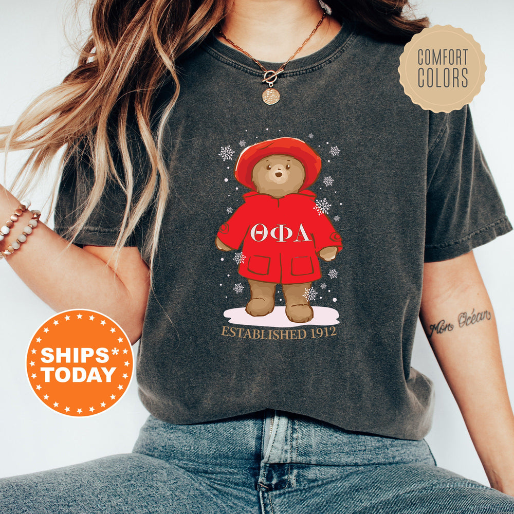 a woman wearing a t - shirt with a teddy bear on it