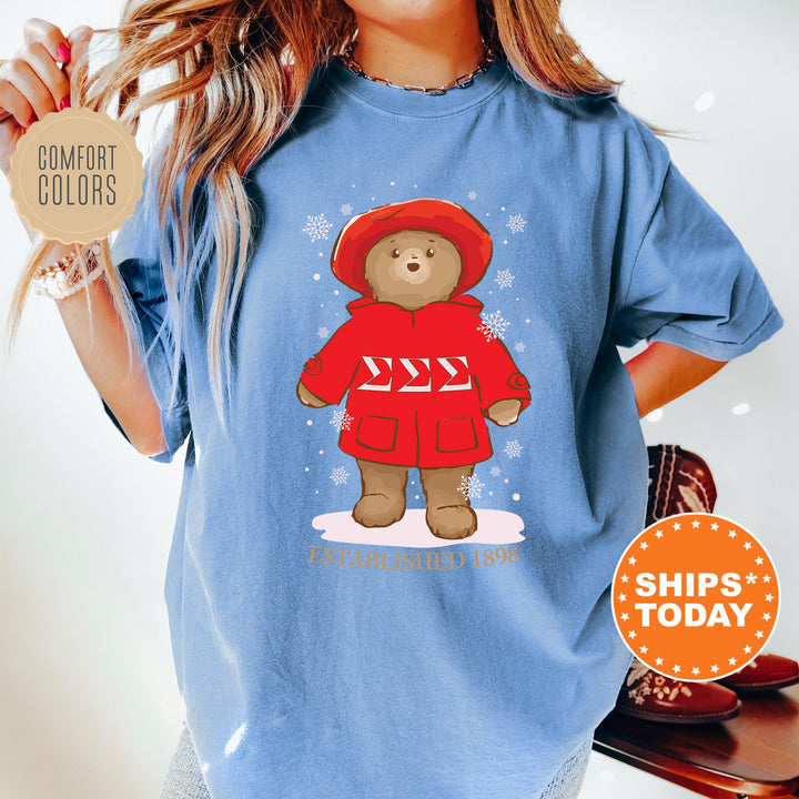 a woman wearing a blue shirt with a teddy bear on it