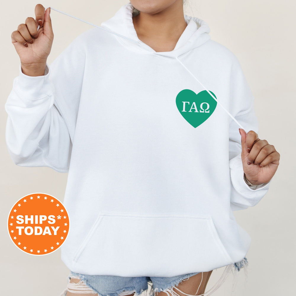 a woman wearing a white hoodie with a green heart on it
