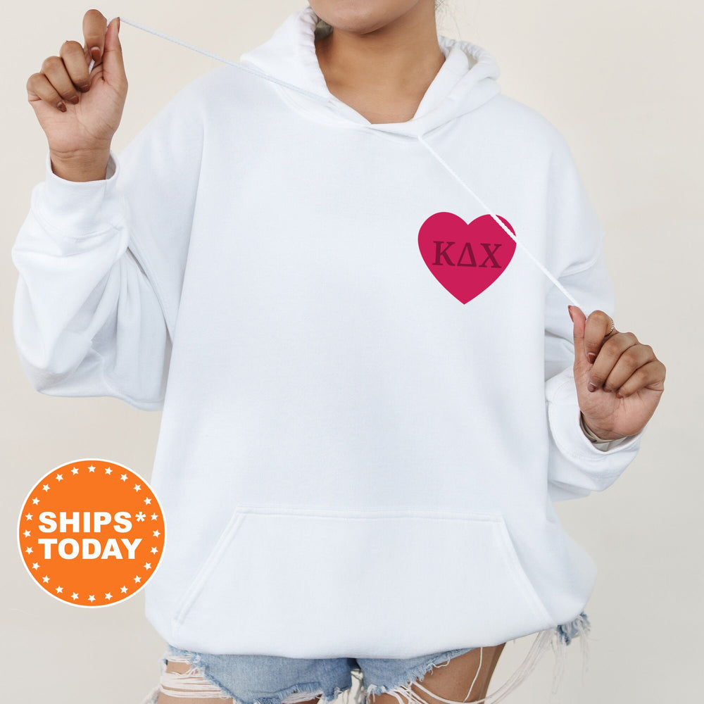 a woman wearing a white hoodie with a red heart on it