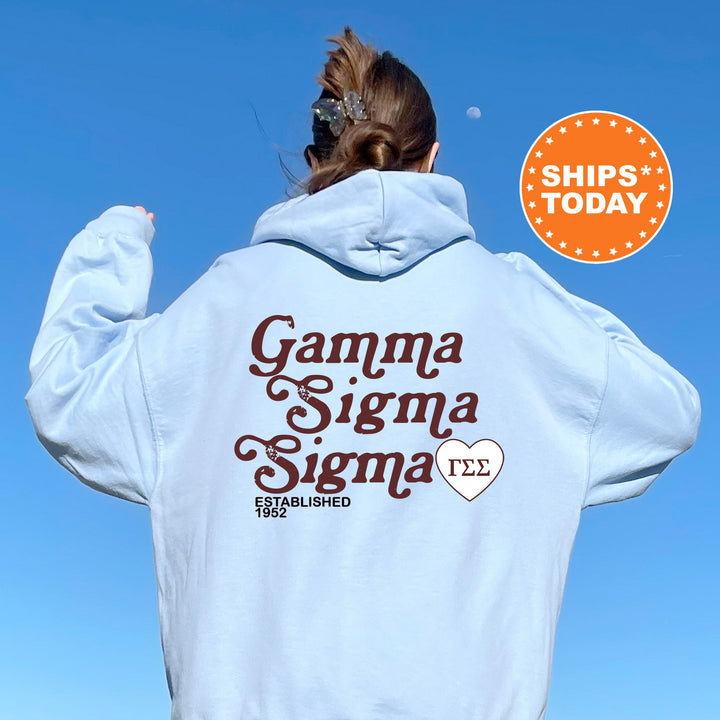 a woman wearing a white hoodie with the words garma sigma si