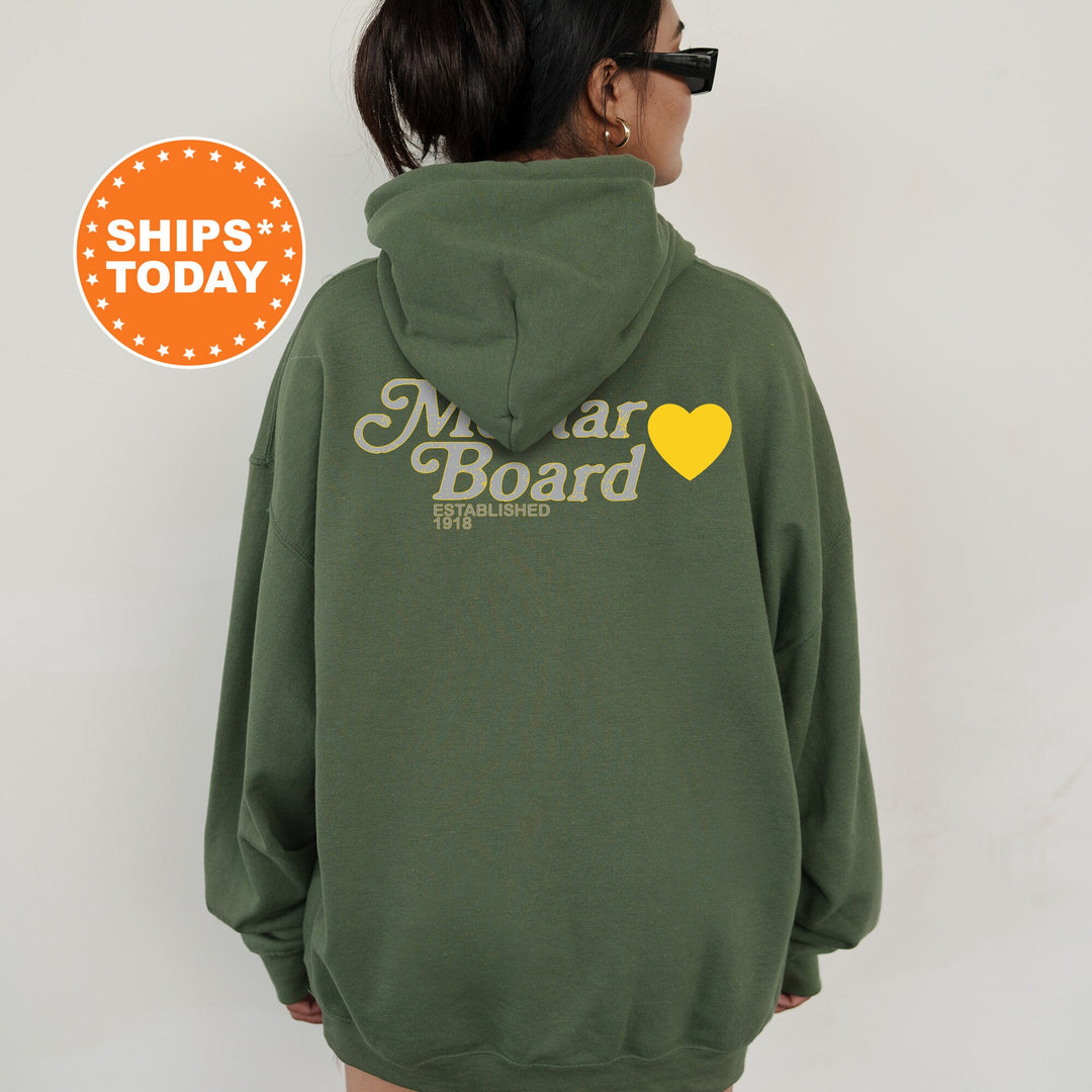 a woman wearing a green hoodie with a yellow heart on it