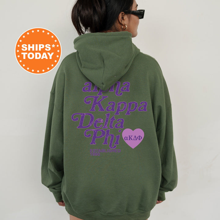 a woman wearing a green hoodie with purple letters on it