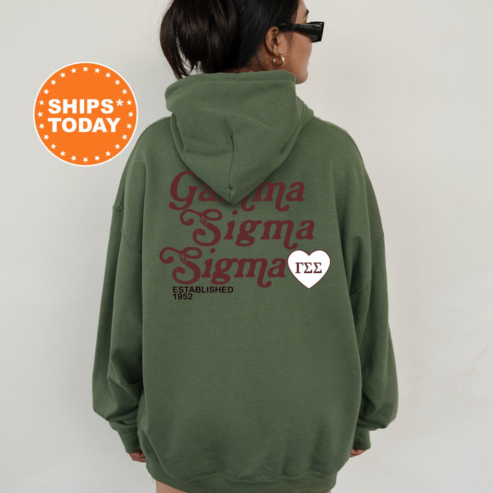 a woman wearing a green hoodie with a heart on it