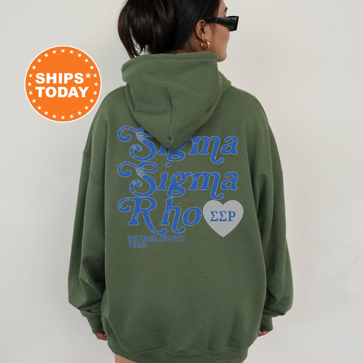 a woman wearing a green hoodie with blue writing on it