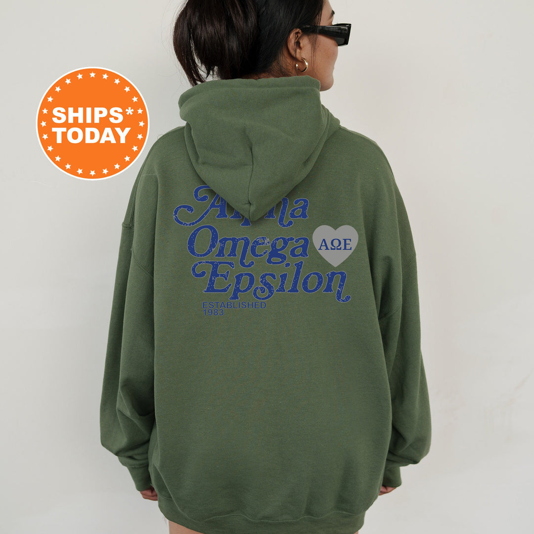 a woman wearing a green hoodie with blue writing on it