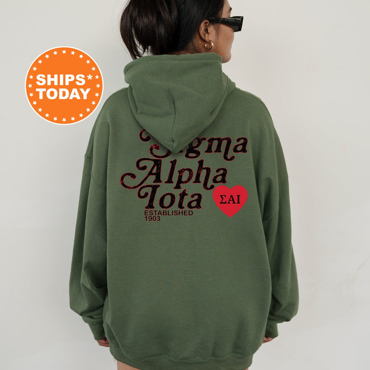 a woman wearing a green hoodie with a red heart on it
