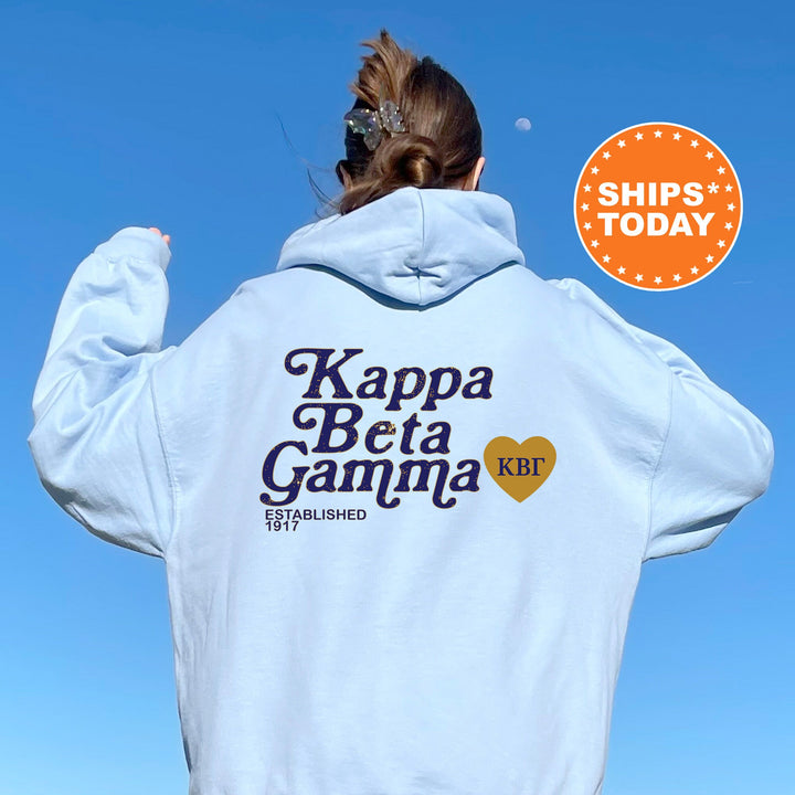 a woman wearing a white hoodie with the words kappa beta ga