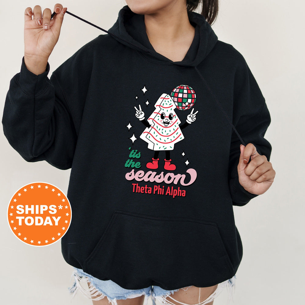 a woman wearing a black hoodie with a santa clause on it
