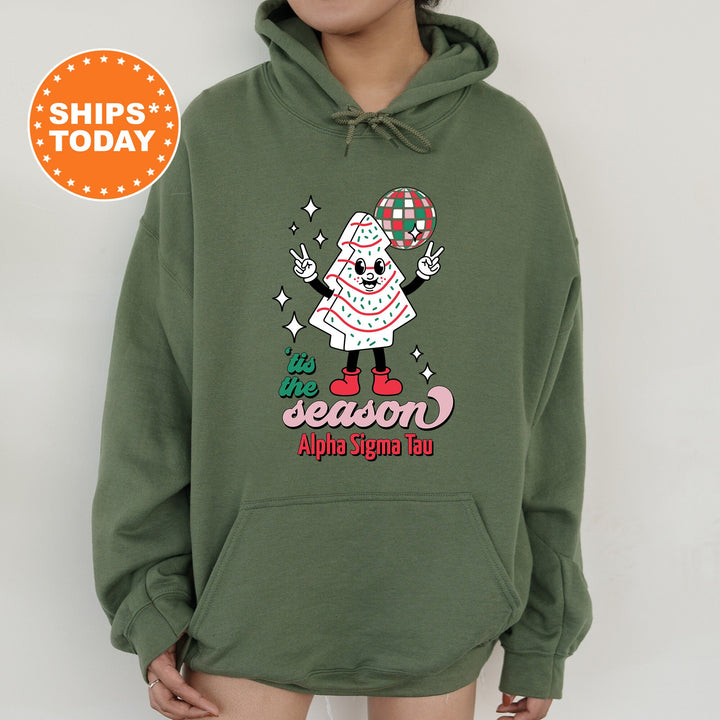 a person wearing a green hoodie with an image of a clown on it