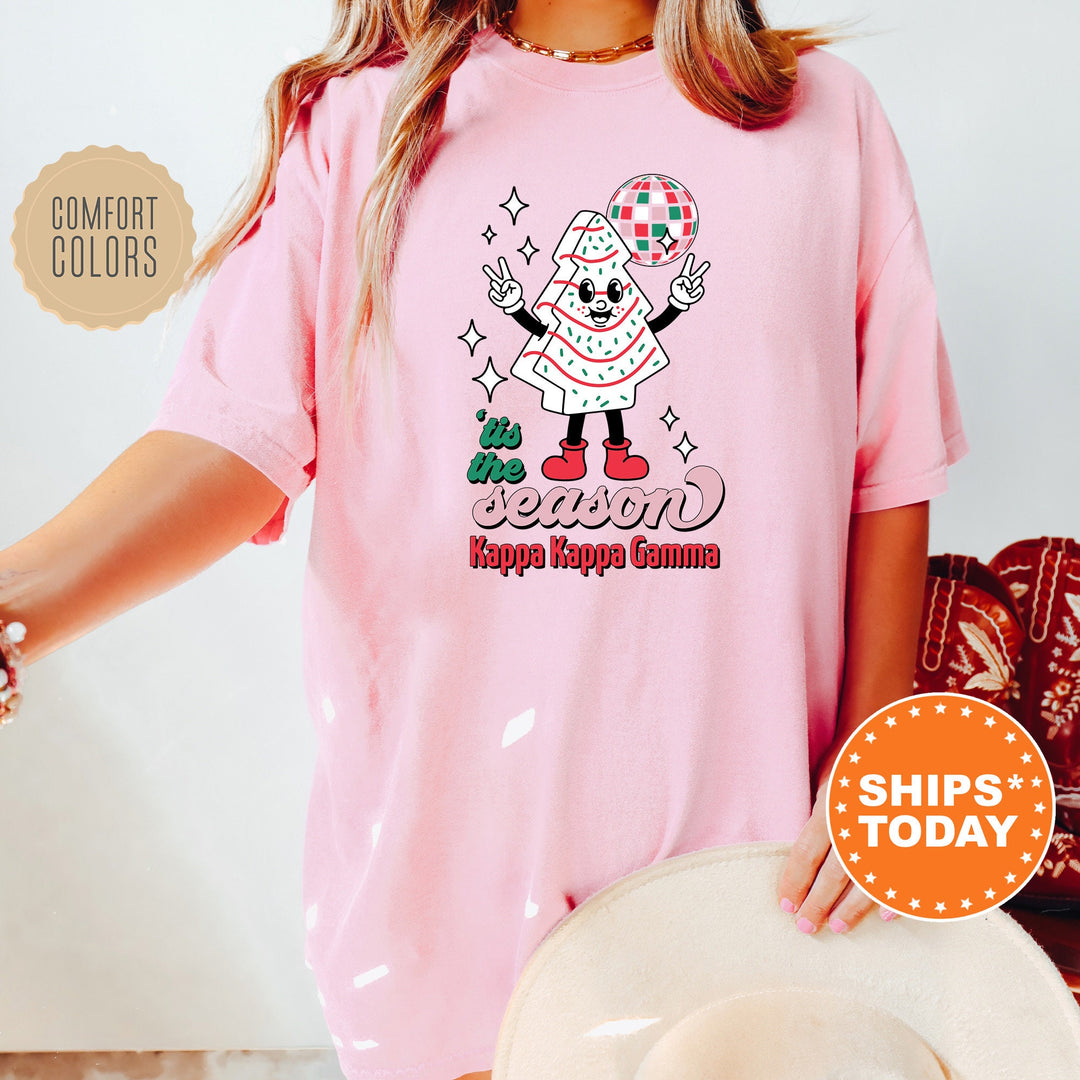 a woman wearing a pink shirt with a santa clause on it