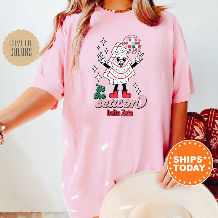 a woman wearing a pink tshirt with a santa clause on it
