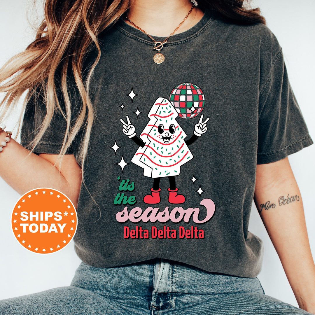a woman wearing a t - shirt that says the season delta delta