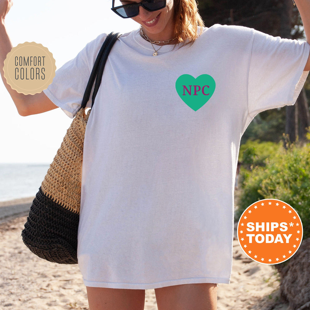 a woman wearing a white shirt with a green heart on it