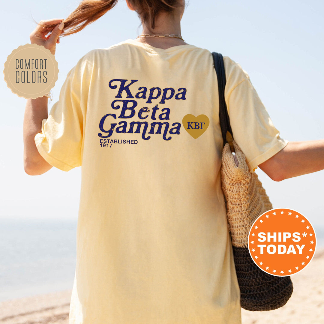a woman with a bag and a t - shirt that says kapa beta