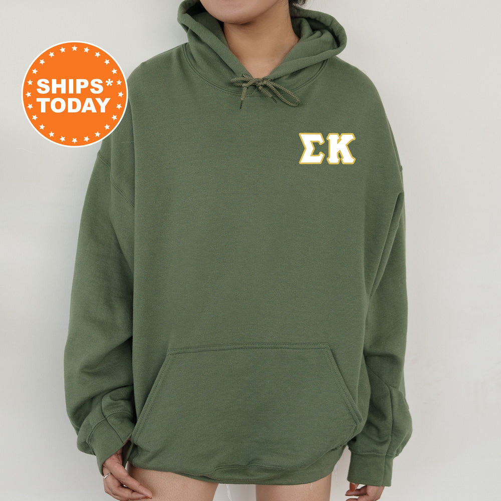 a person wearing a green hoodie with the letter k on it
