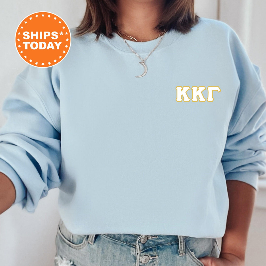 a woman wearing a blue sweatshirt with the letters kkt on it