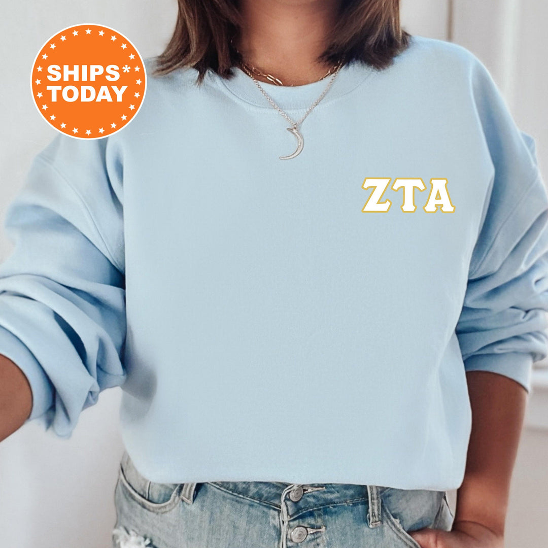 a woman wearing a blue sweatshirt with the letters zta on it