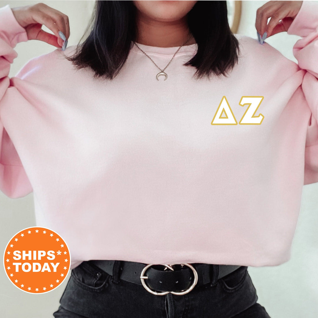 a woman wearing a pink sweatshirt with the letters a to z on it