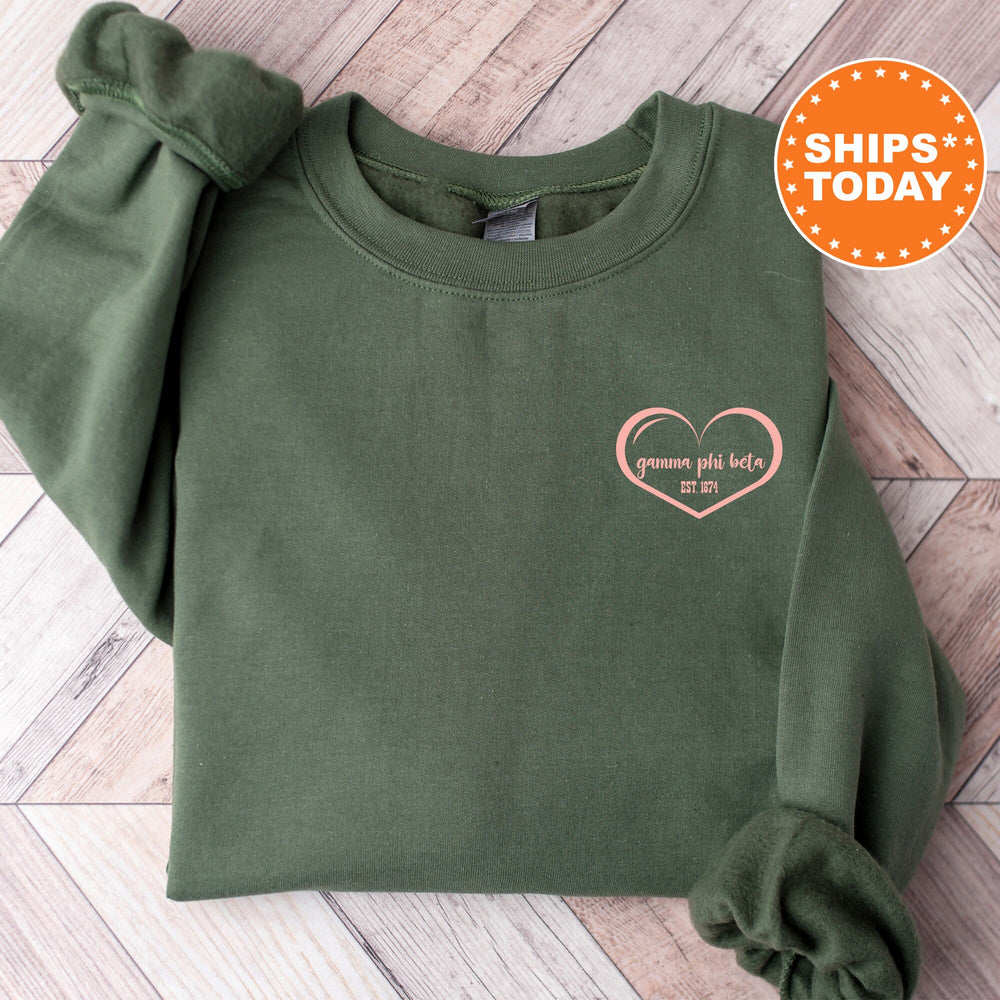 a green sweatshirt with a pink heart on it