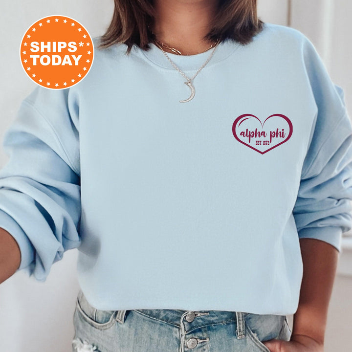 a woman wearing a blue sweatshirt with a heart on it