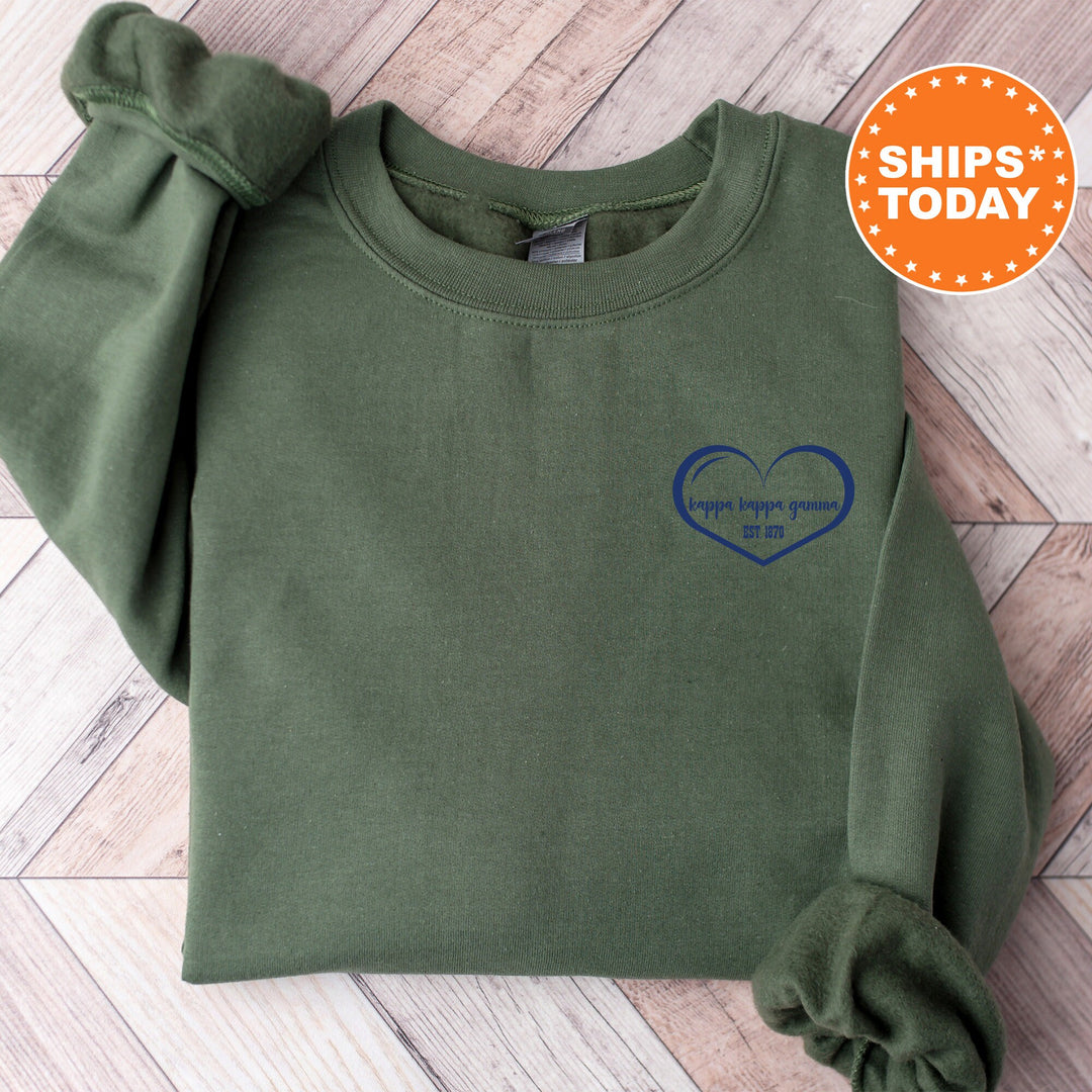 a green sweatshirt with a blue heart on it