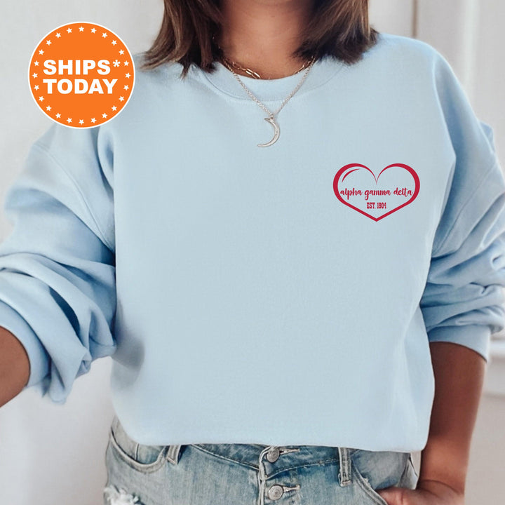 a woman wearing a blue sweatshirt with a red heart on it