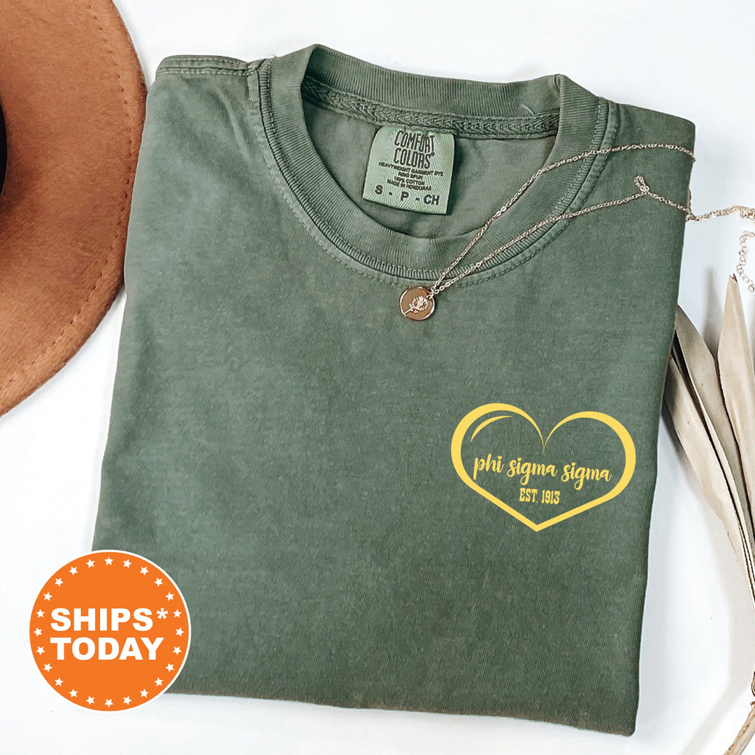 a green t - shirt with a yellow heart on it