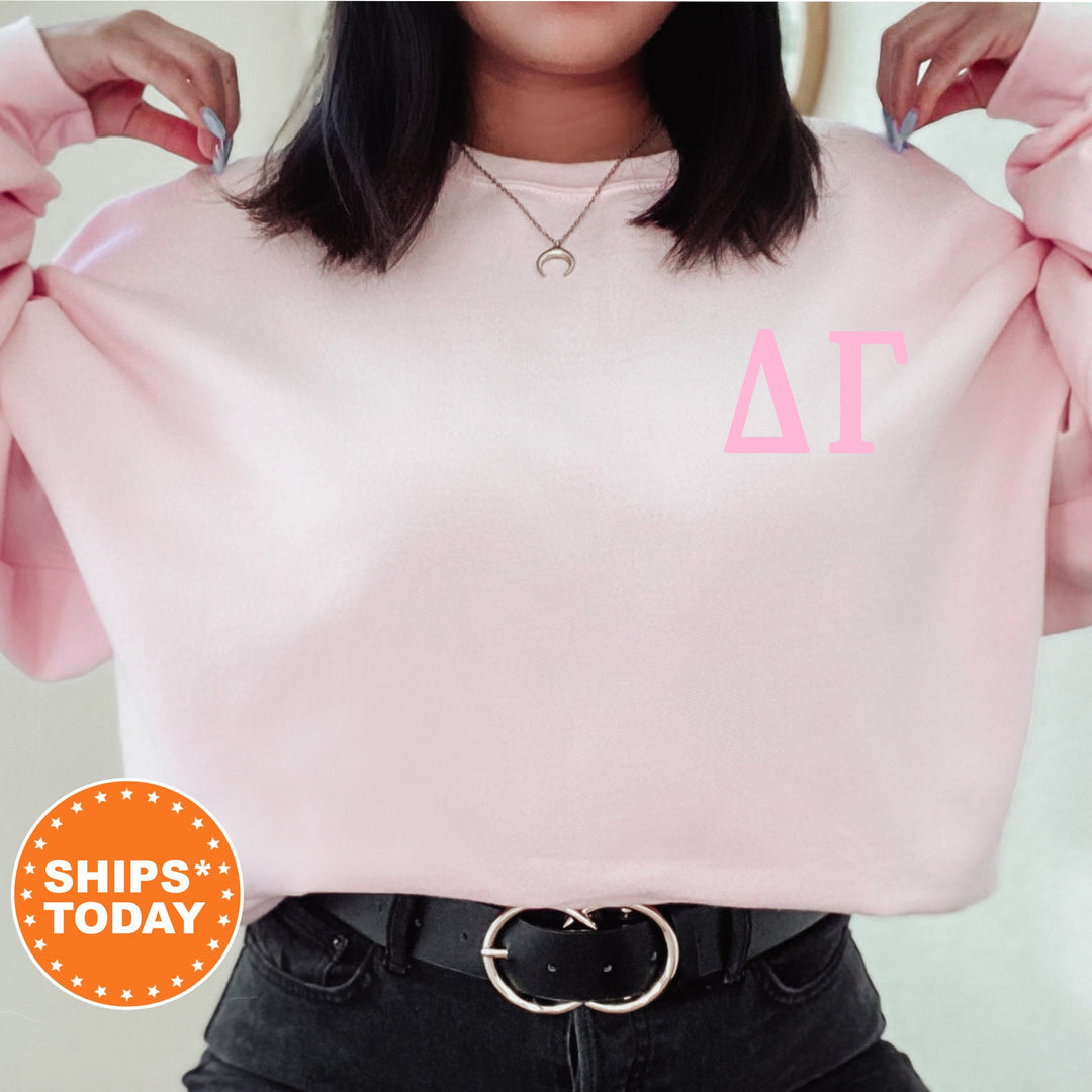 a woman wearing a pink sweatshirt with the letter a on it