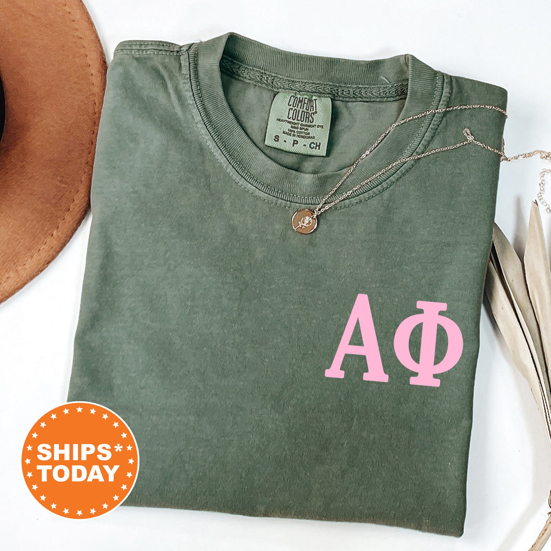 a green shirt with a pink phi phi symbol on it