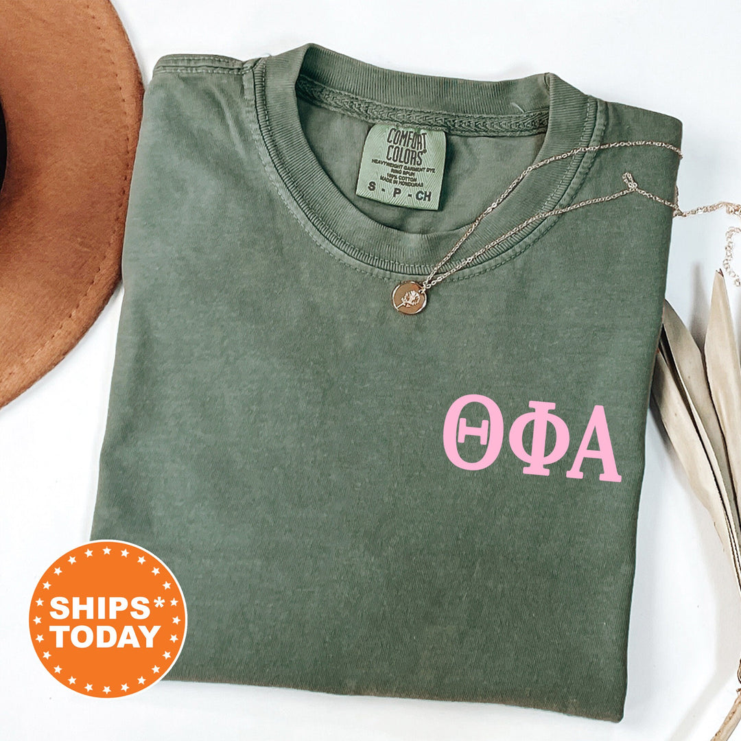 a green shirt with a pink phi phi on it