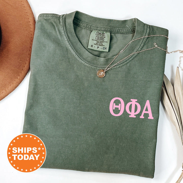 a green shirt with a pink phi phi on it