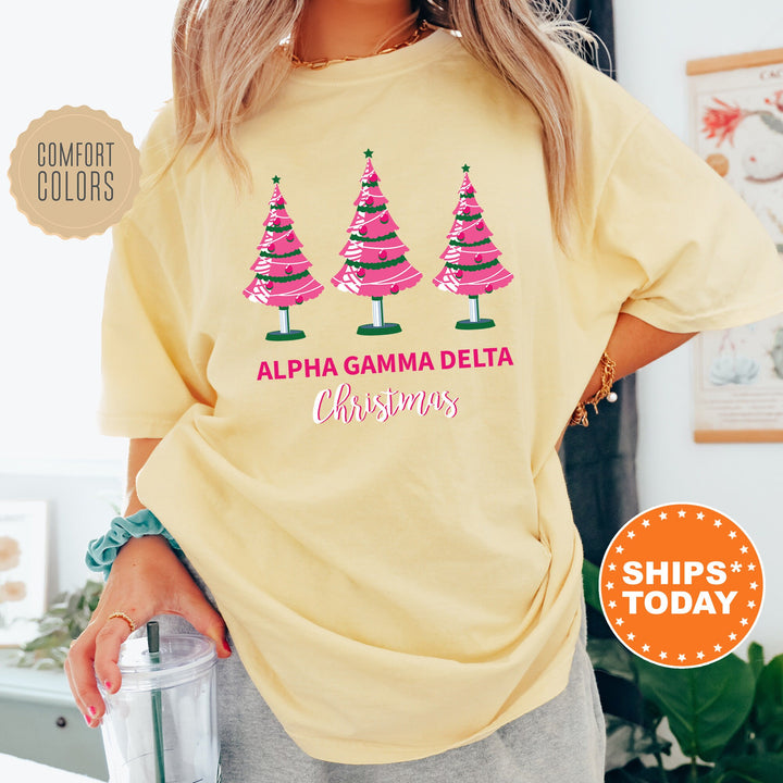 a woman wearing a yellow shirt with christmas trees on it