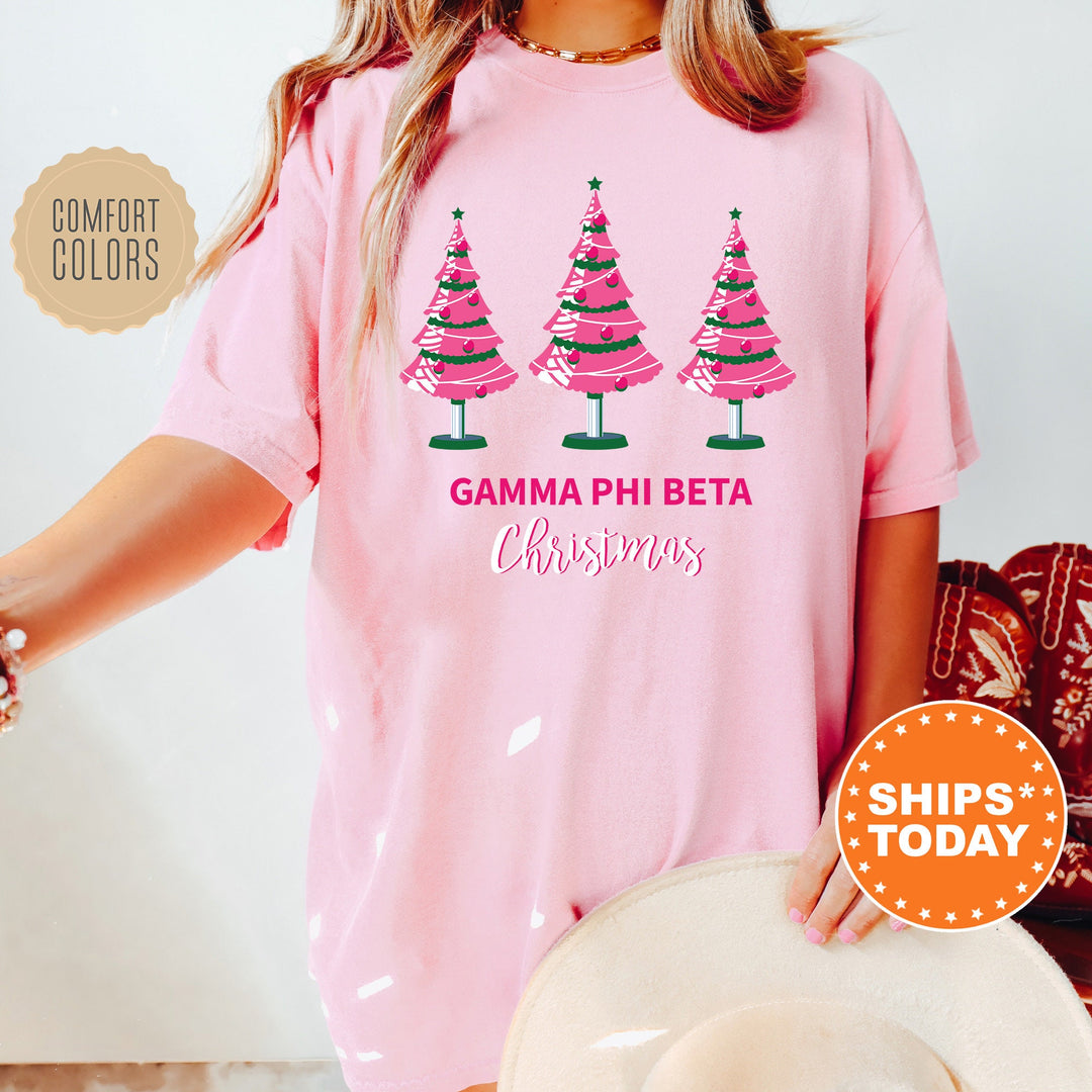 a woman wearing a pink shirt with christmas trees on it