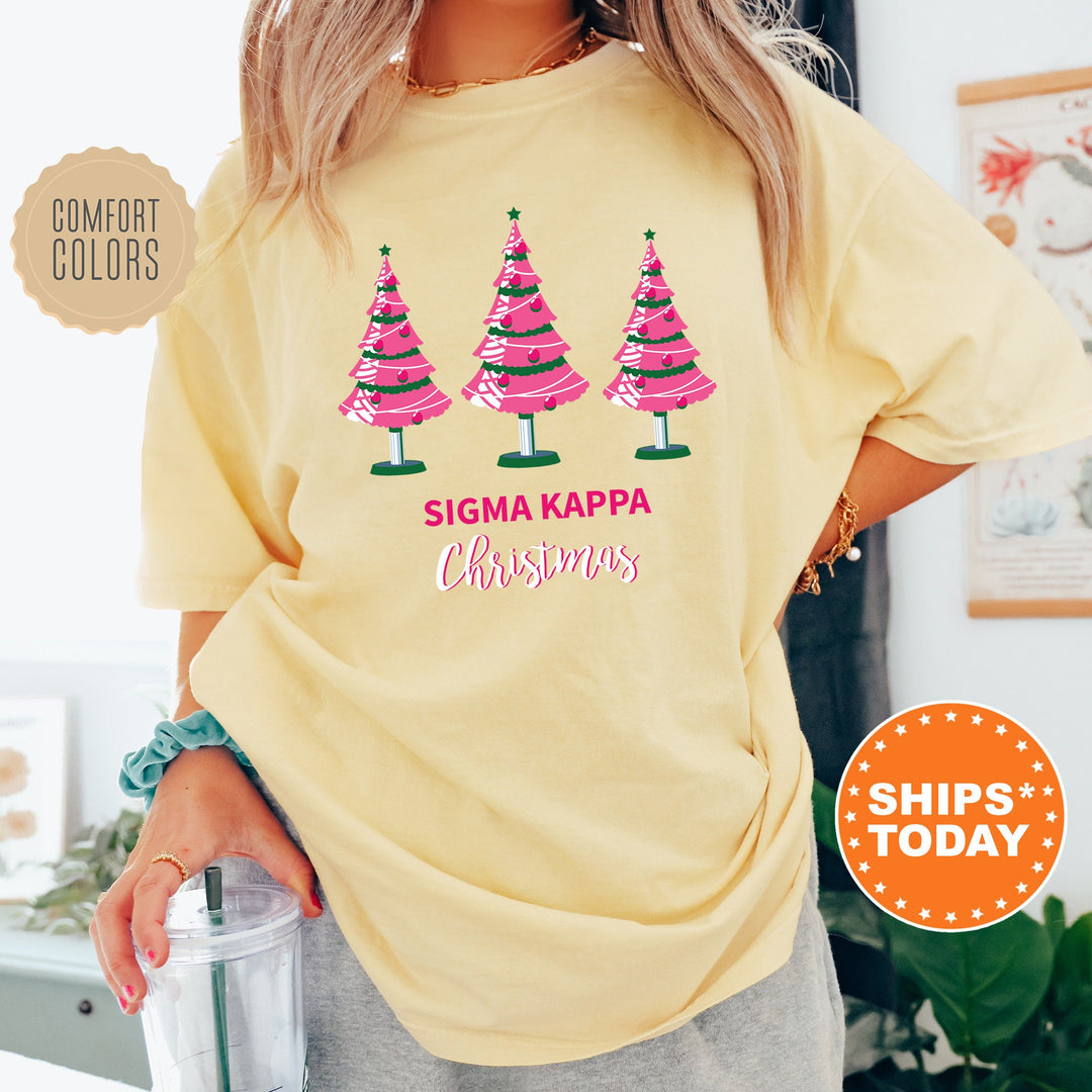 a woman wearing a yellow shirt with christmas trees on it