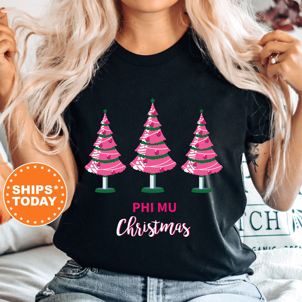 a woman wearing a black shirt with pink christmas trees on it