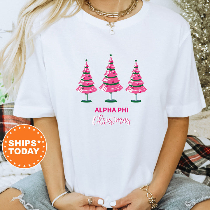 a woman wearing a white shirt with christmas trees on it