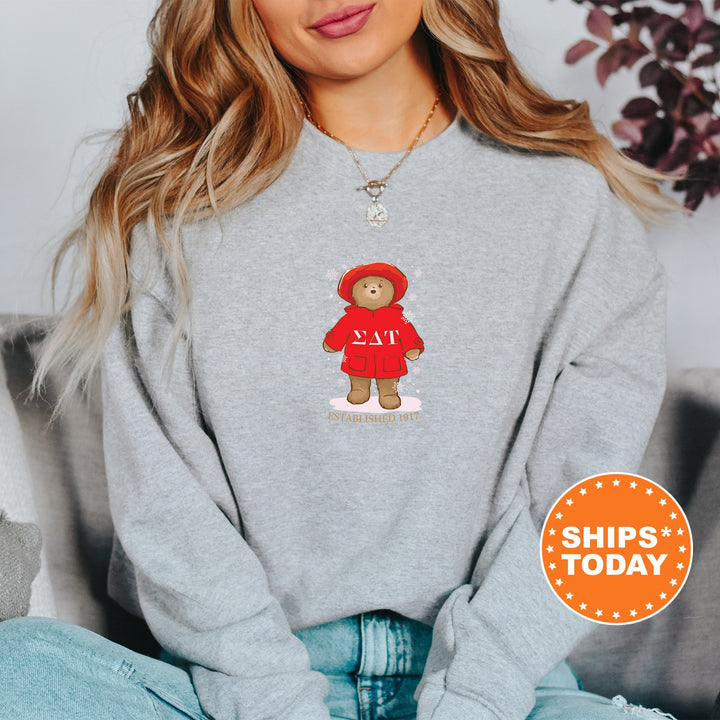 a woman wearing a sweatshirt with a teddy bear on it