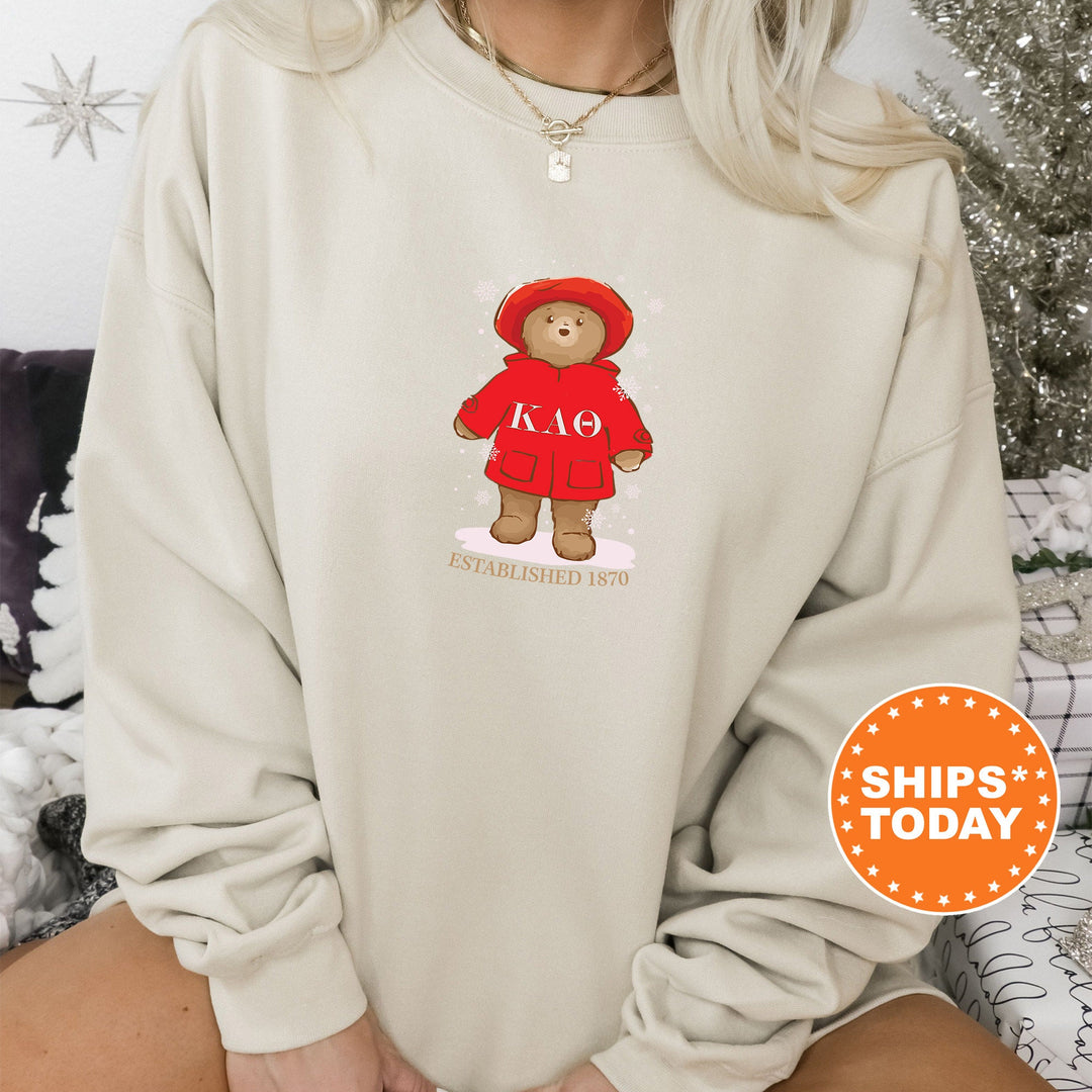 a woman wearing a sweatshirt with a teddy bear on it