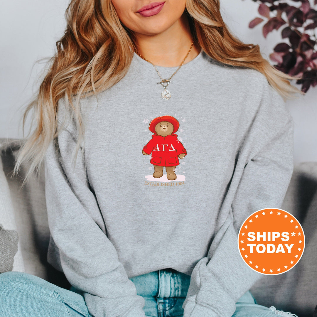 a woman wearing a sweatshirt with a teddy bear on it