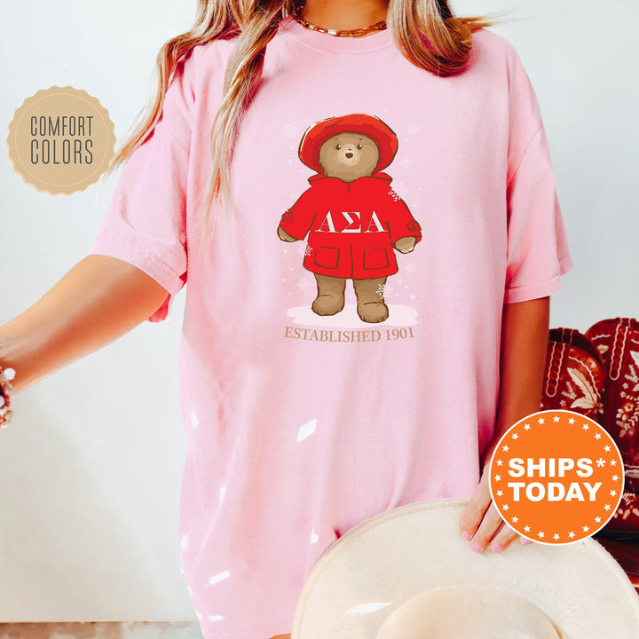 a woman wearing a pink shirt with a teddy bear on it