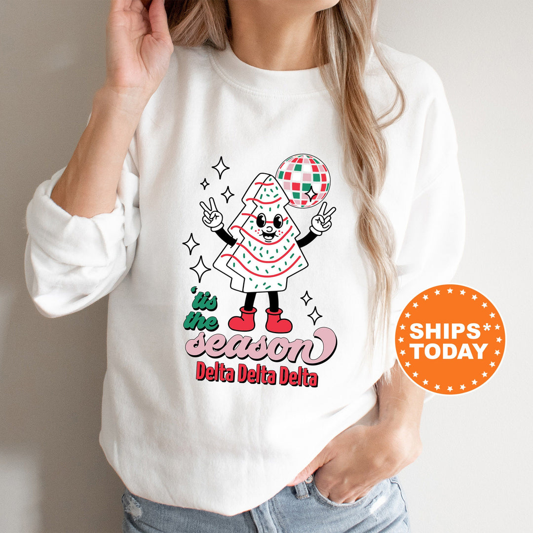 a woman wearing a white shirt with a santa clause on it