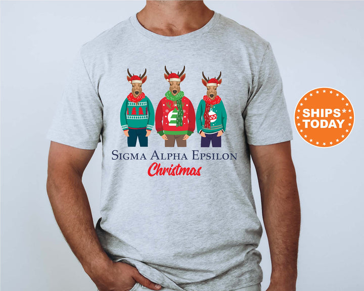 a man wearing a christmas shirt with three reindeers wearing ugly sweaters