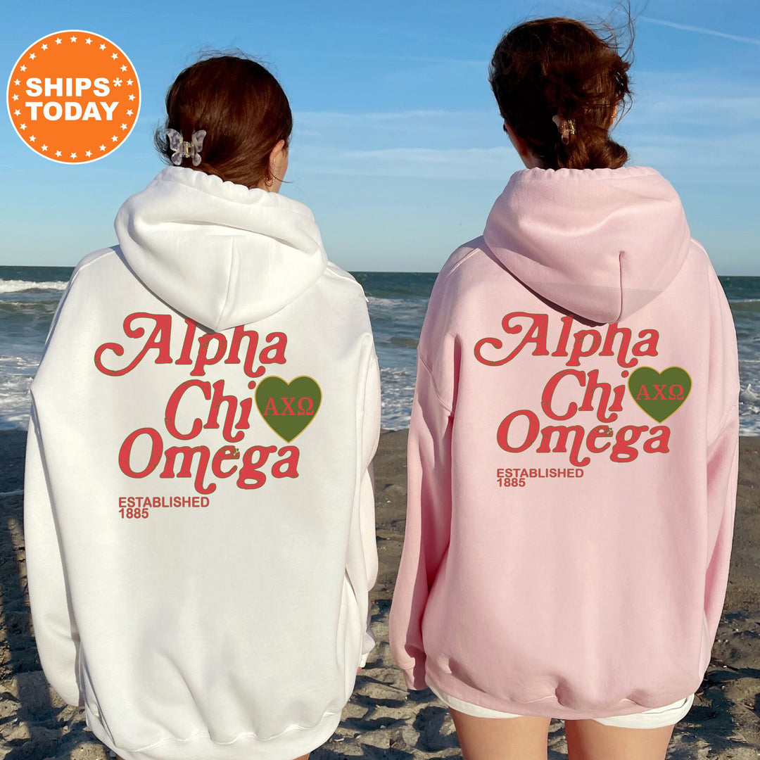two girls wearing pink and white hoodies on the beach